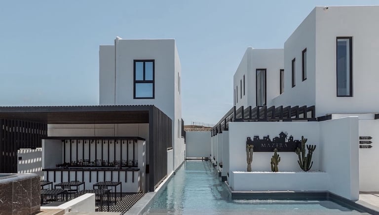 a pool with lounge chairs and a pool