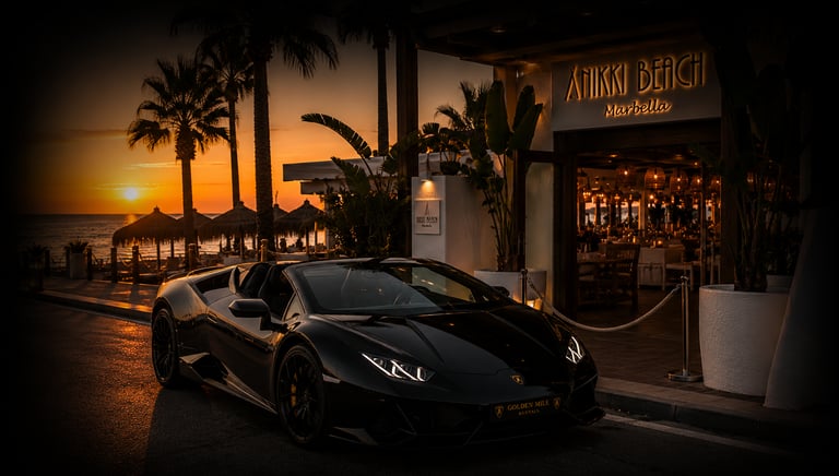 Black Lamborghini luxury car rental parked outside Nikki Beach Marbella at sunset.