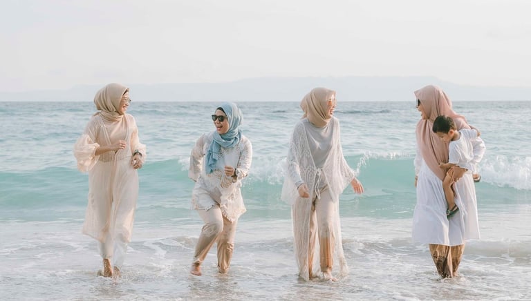 Group of friends walking along the shoreline during photoshoot at Candi Beach Resort Karangasem Bali