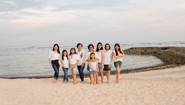 Extended family walking along the beach at The Ritz-Carlton Bali in Nusa Dua during a relaxed family photoshoot