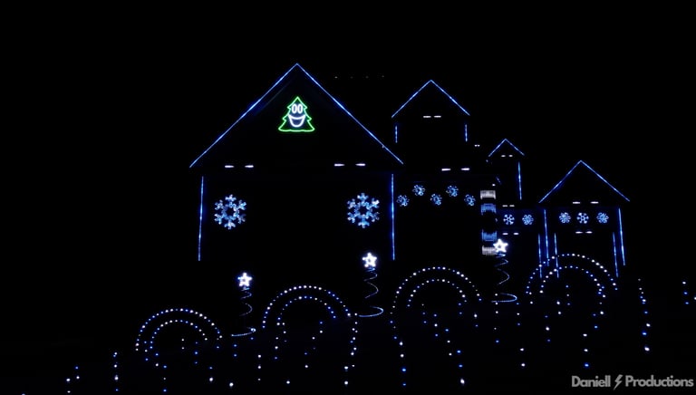 An animated Christmas light show at night