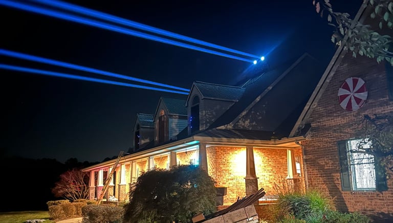 Beams of light shining off of a house