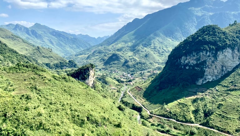 a mountain view of a valley with a winding road