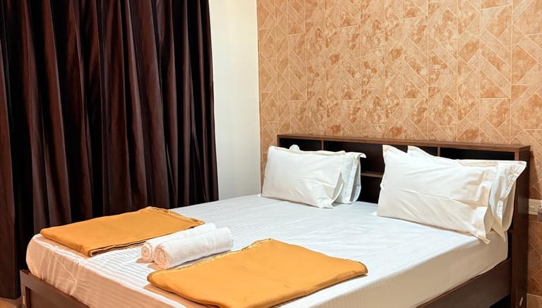 a bed with two pillows and a blanket on it