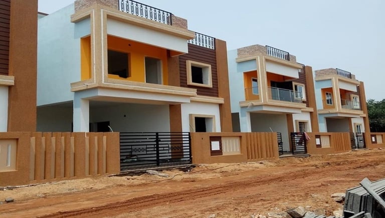 a row of three story houses with a fenced in area by DARSANS Infraa