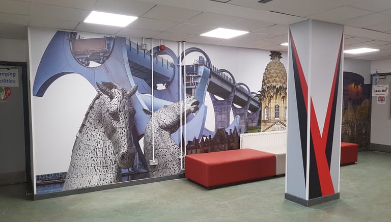 a large wall mural of a large mural of a woman in a red dress