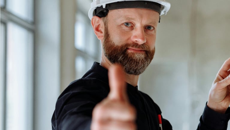 A Service Buisness Tech giving the thumbs up on a booked job site  Photo by Thirdman 