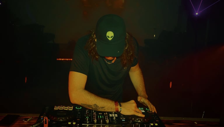 a man in a hat and a hat on a dj booth