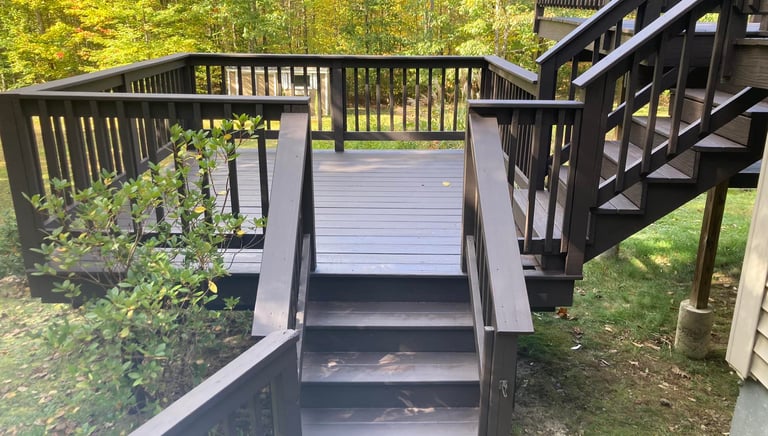 a wooden deck with a staircase leading to a deck