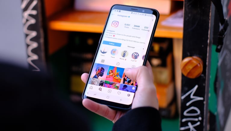 a person holding a cell phone in their hand seeing social media