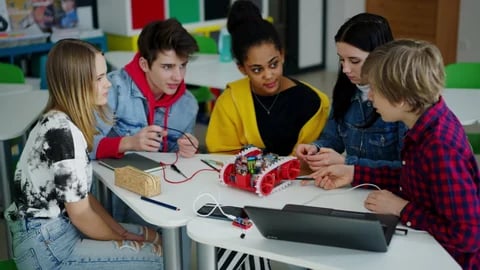Middle school students discussing robotics