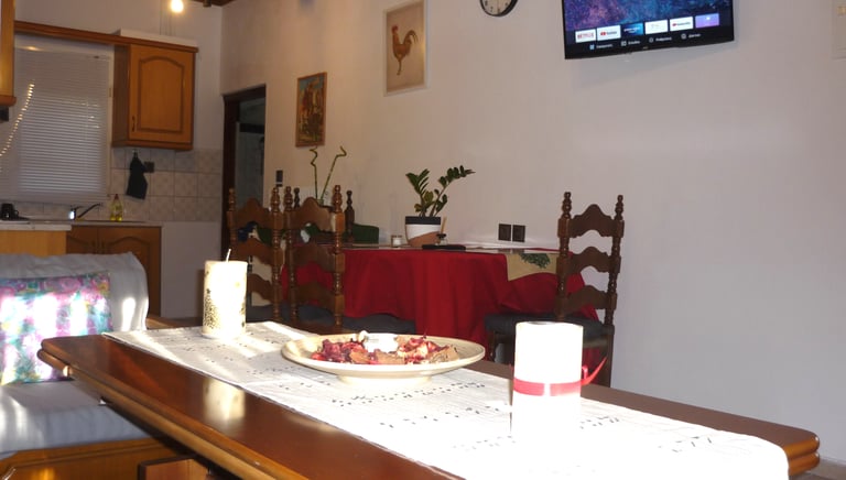 a table with a bowl of fruit and candles