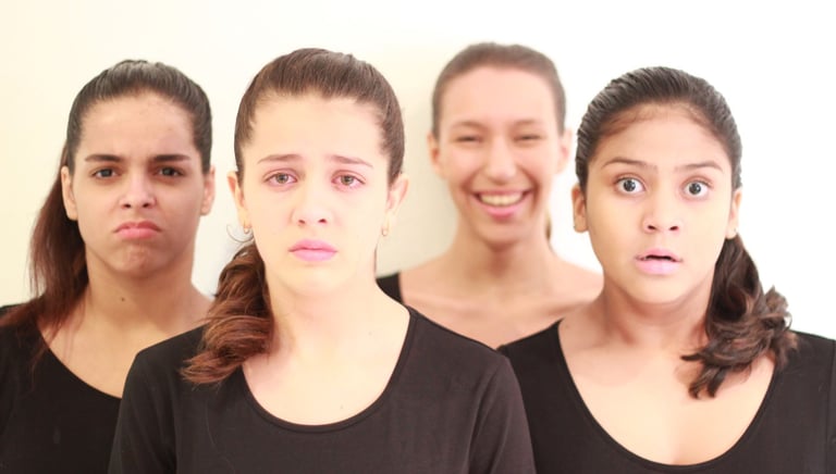 a group of people standing in front of a white wall