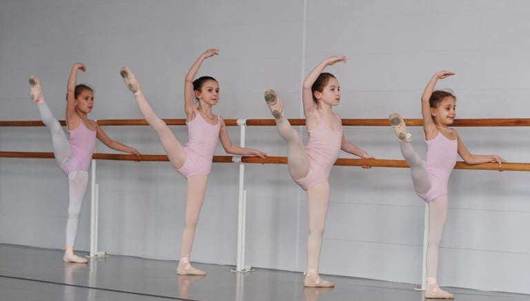 a group of young girls in ballet enjoying class