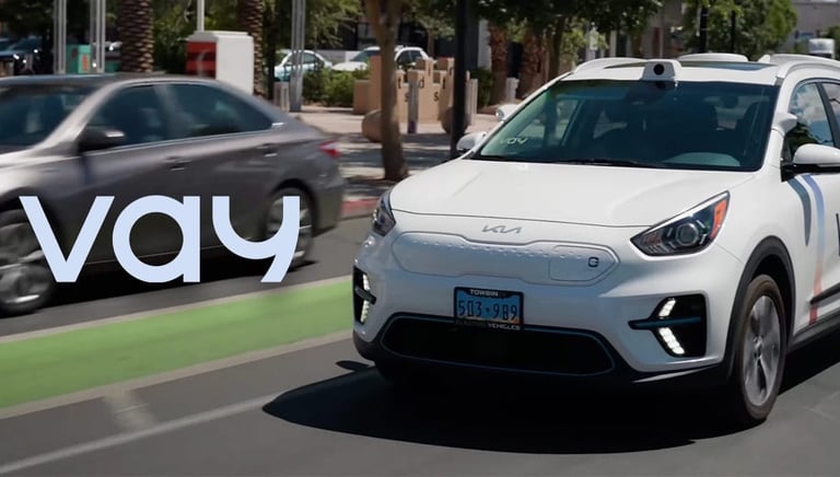 White self-driving electric car with roof-mounted sensor driving on a city street.