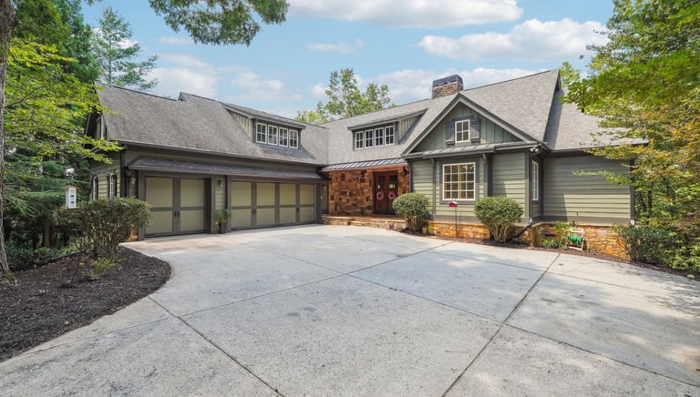 a large house with a driveway showing achasta real estate