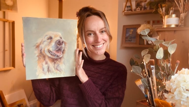 A photograph of Alex with one of her paintings