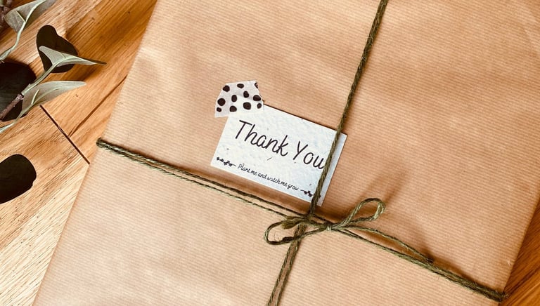 A painting packaged nicely in brown paper and green string