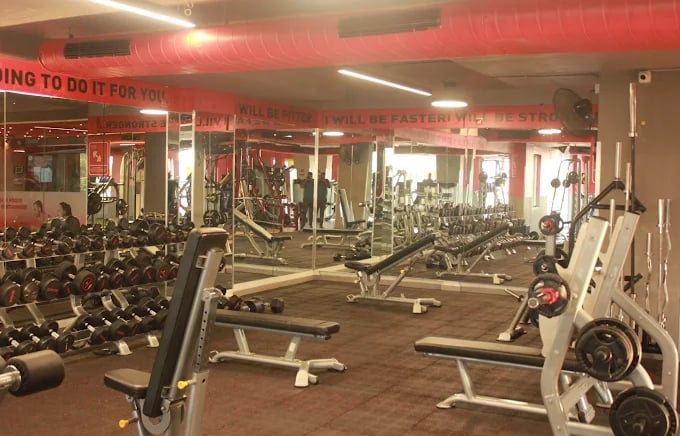 Strength training zone at FitX1 Bangalore featuring a wide range of free weights, power racks, and p