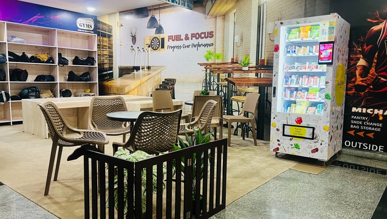FitX1 Manikonda relaxing lounge and cafe with snack vending machines and member shoe storage area.