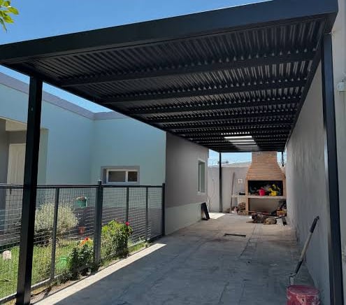 a patio with a fire place and a grill