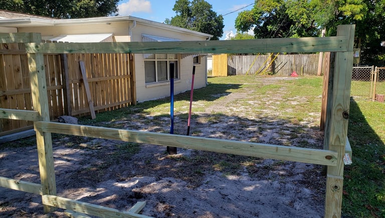 Handyman installing wood picket fence