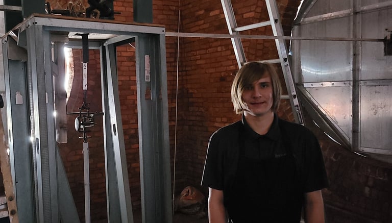 The owner of the lutz clock company inside a tower clock