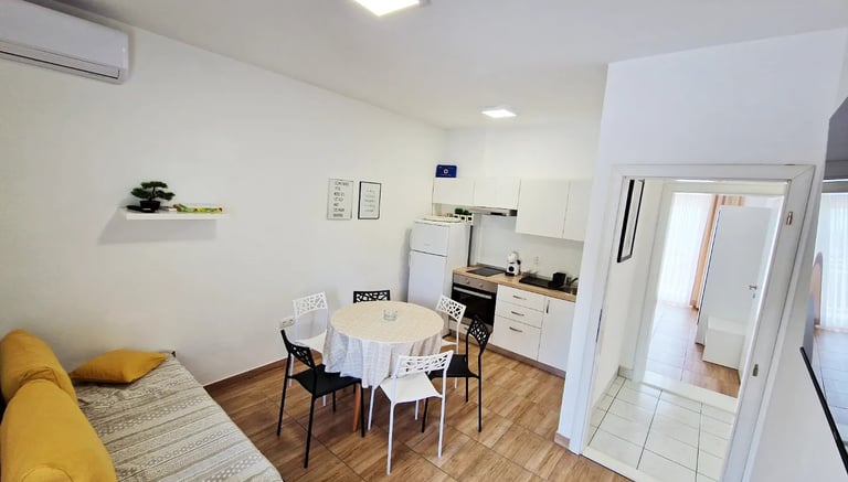 a kitchen and dining room with a table and chairs