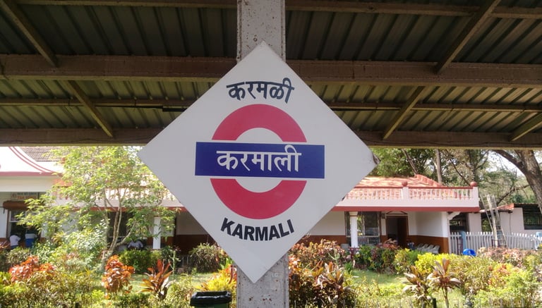 a sign that says Karmali in Marathi, english and hindi