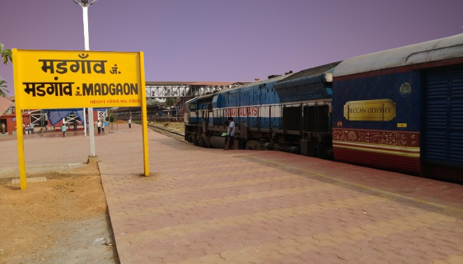 a margao railway station with a train on the tracks