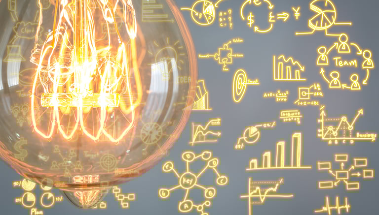 Glowing light bulb with business strategy icons representing innovation and creative planning.