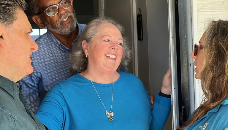 a group of people standing around a door