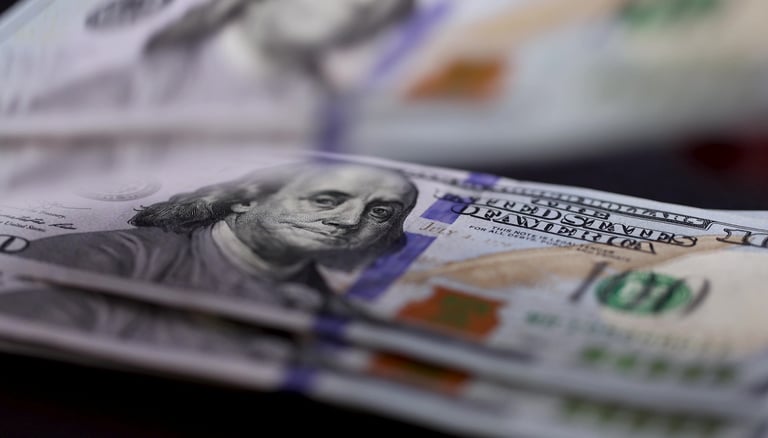 100 dollars bills on a table for a minimum investment