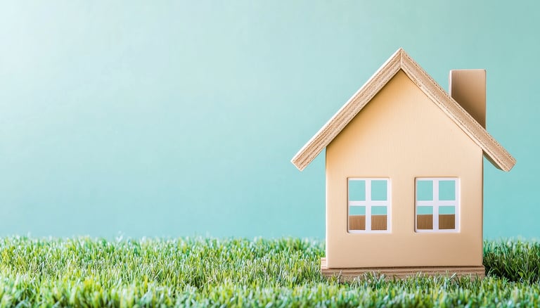 mini house on grass for symbolizing real estate ira investing