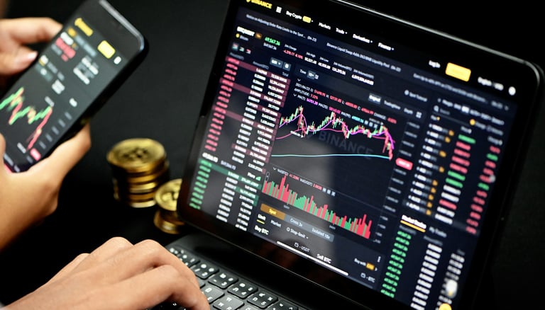 person trading on their computer with bitcoin on the side