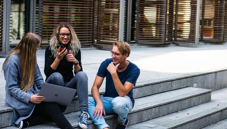 group of young millennials chatting in group on stairs representing gold ira for millennials