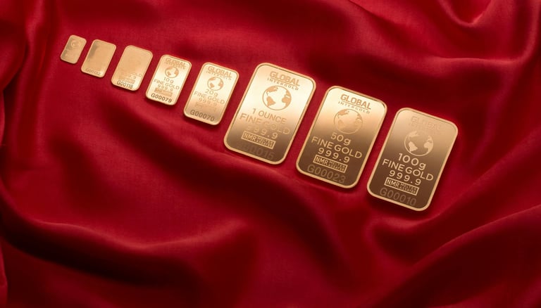 gold bars layed out in a row symbolizing blog post augusta precious metals, a gold ira company and why you should choose them