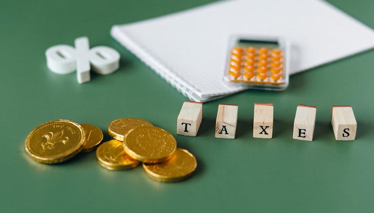 gold coins, calculator and word taxes show gold ira taxes and learning potential tax benefits