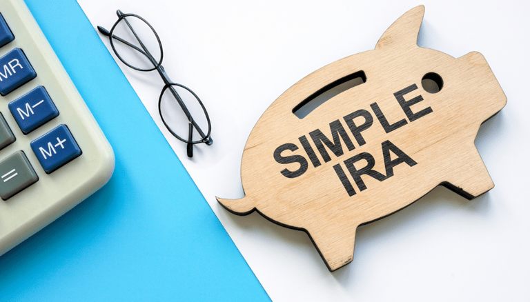 piggy bank a calculator and glasses for a simple ira