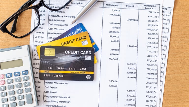 glasses a calculator and credit card for managing credit