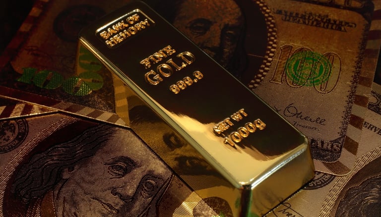 gold bar on top of US money
