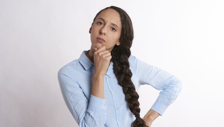 woman thinking thoroughly and wondering if gold ira is a scam