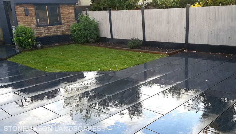 Grey sandstone circle paving slabs with charcoal edging