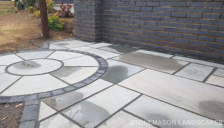 Grey sandstone circle paving slabs with charcoal edging