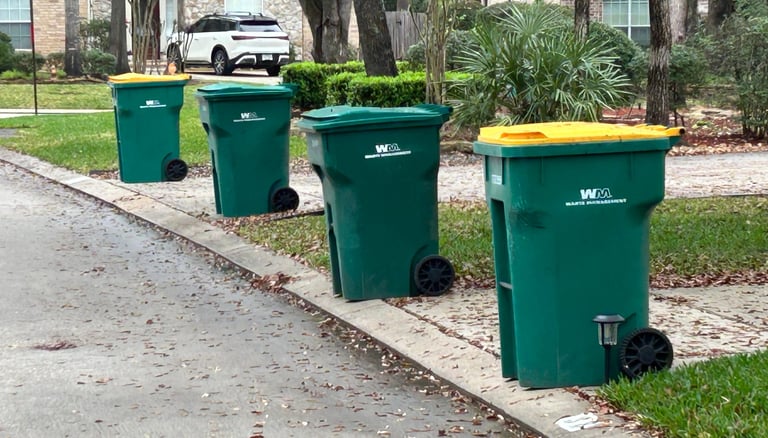 Trash Can Caddie valet service lining up green and yellow trash cans for pickup in The Woodlands, Te