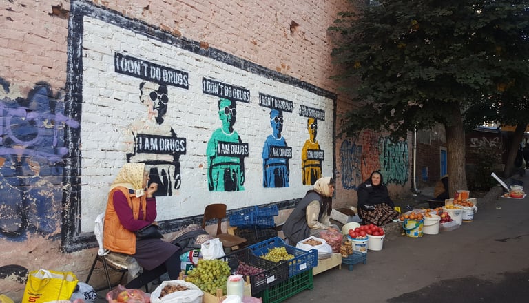 Street photography of woman in Ukraine in front of street art in a market