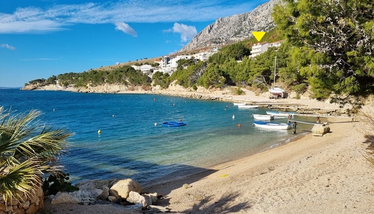 The photo shows the coastal part of Lokva Rogoznica with boats and houses above.