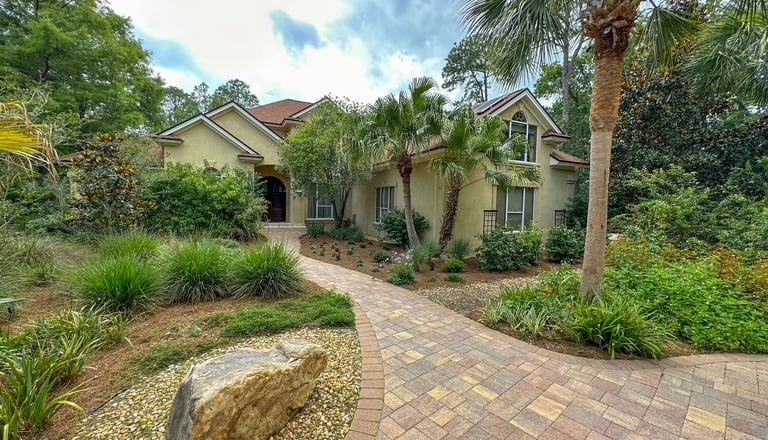 a house with a brick walkway and a stone path