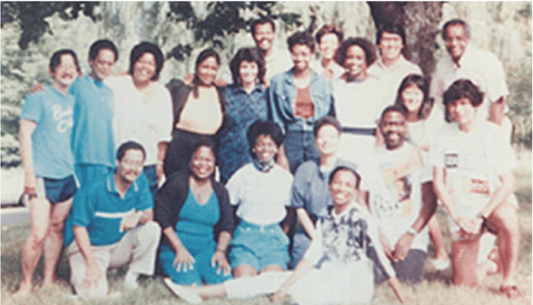 a group of people standing around a tree