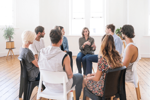 a group of people sitting around a table